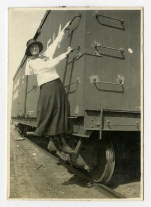 Primary view of object titled '[Girl Holding onto Side of Boxcar]'.