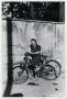 Photograph: [Photograph of Young Woman on Bicycle]