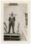 Photograph: [Photograph of Johnny Poulos Outside Barracks]