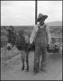 Photograph: [Man Posing with Donkey]