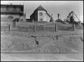 Photograph: [Buildings on the Side of an Embankment]
