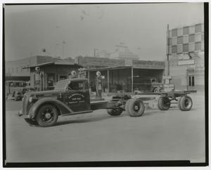 Primary view of object titled '[Truck Parked by Auto Parts Shops]'.