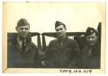 Photograph: [Three Men in Front of Jeeps]