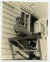 Photograph: [Photograph of Soldier on Barracks Porch]