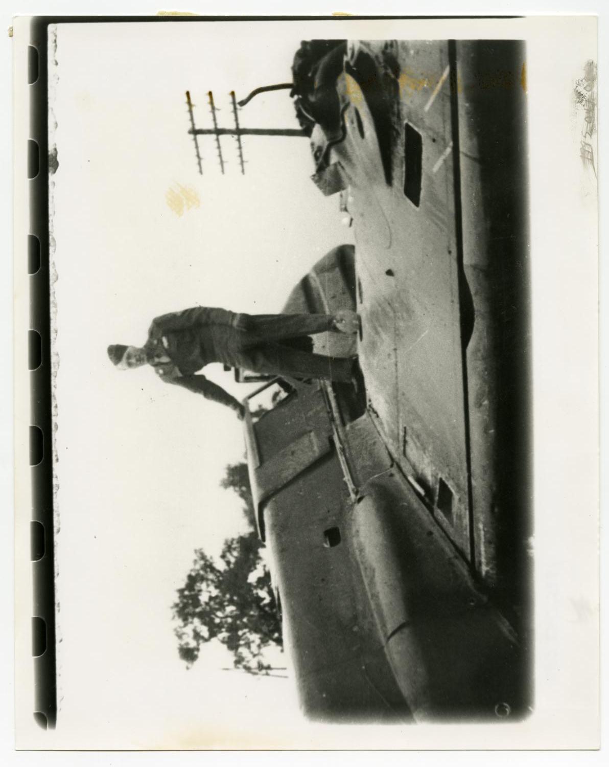 [Photograph of Soldier on Airplane]
                                                
                                                    [Sequence #]: 1 of 2
                                                