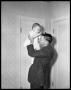 Photograph: [Man Holding Baby Above Head]