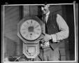 Photograph: [Man with Clock]