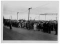 Photograph: [People Standing on the Side of a Street]