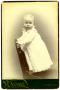 Photograph: [Portrait of a Baby Standing on a Chair]