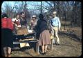 Photograph: [Men and Women around an Outdoor Picnic Table]