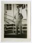Photograph: [A Soldier Standing in Front of a Building]