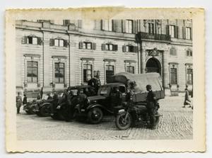 Primary view of object titled '[German Soldiers Standing Next to Trucks and Motorcycles]'.