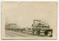 Photograph: [Wrecked German Cars on Flat Bed Rail Cars]