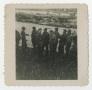 Photograph: [A Group of Soldiers Standing on the Rail of a Ship]