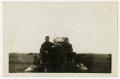 Photograph: [Men Sitting on Either Side of Artillery Gun]