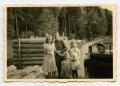 Photograph: [A Soldier Standing with Three Civilian Girls]