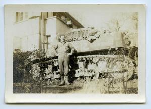 Primary view of object titled '[Earl Steinbrink Next to a Tank]'.