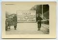 Photograph: [Two Soldiers Standing by an Identification Sign]