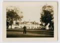 Photograph: [Photograph of a Sailor in Front of a Building Complex]