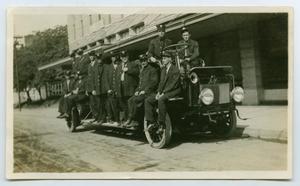 Primary view of object titled '[Photograph 12 Firemen on a Service Truck]'.