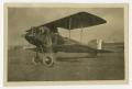Photograph: [Photograph of a Pilot Working on His Plane]