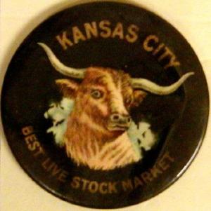 Primary view of object titled '[Black button with image of a longhorn in the center that states: "KANSAS CITY BEST LIVE STOCK MARKET"]'.
