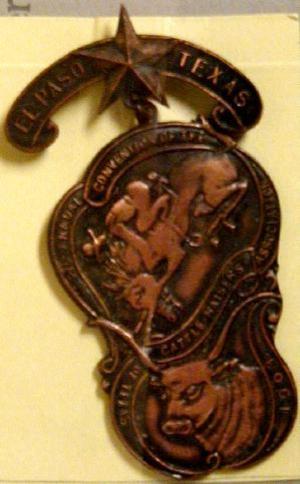 Primary view of object titled '[Two tiered bronze El Paso livestock pin]'.