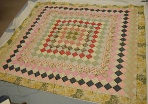 Primary view of object titled '3" squares of multi-colors with floral border on quilt.'.