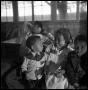 Photograph: [Children Sitting in Cookshack]