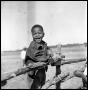 Photograph: [Boy Standing on a Fence]