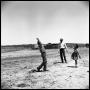 Photograph: [Jack Newcomb Roping a Child]