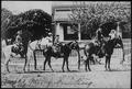 Postcard: [Postcard image of three people on horseback in front of a house]