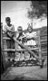 Primary view of [Three Children Standing on a Fence]
