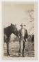 Photograph: [Photograph of a Man Holding a Horse]