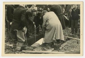 Primary view of object titled '[Photograph of a French Casket Being Lowered into the Ground]'.