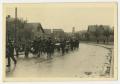 Photograph: [Photograph of a Parade of People Walking Down a Street]