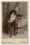 Photograph: [Portrait of John K. Strecker Sitting on a Bench in a Costume]
