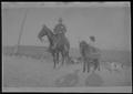 Postcard: [Postcard image of a man on horseback and a  child on a pony]