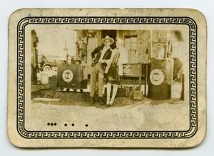 Primary view of object titled '[Photograph of a Unknown Couple at a Gas Pump]'.