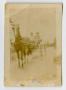 Photograph: [Photograph of Two Unknown Men in a Horse-Drawn Wagon]