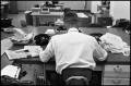 Photograph: [Man Working at Desk at Beaumont Enterprise #8]