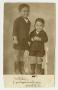 Photograph: [Photograph of Two Young Siblings Posing for Holiday Pictures]