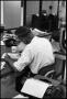 Photograph: [Man Working at Desk at Beaumont Enterprise #25]