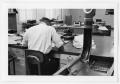 Primary view of [Man Working at Desk at Beaumont Enterprise #30]