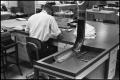Photograph: [Man Working at Desk at Beaumont Enterprise #10]