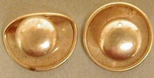Primary view of object titled '[A pair of gold button cuff links underneath states: "KREMENTZ PLATE"]'.