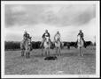 Primary view of [Photograph of four cowboys on horseback in a pasture on the George Ranch]