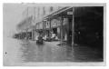 Photograph: [Men Riding in Boat in Flood Waters]