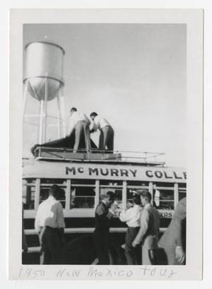 Primary view of object titled '[Photograph of Men Loading McMurry College Bus]'.
