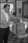 Photograph: [Man Depositing His Ballot in Container]